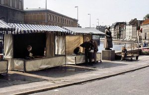 Two of the last remaining fish selling stands at the end of Gammel Strand. John is sitting next to the statue called 'the last fish wife',
