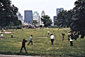 Young people playing football in one of the innumerable fields in the Park. Central Park West in the background