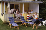 Over to Falsterbo. All of us, except the photographer assembled around the porch of the yellow little house. Kajsa ans Sara in the front at a table.